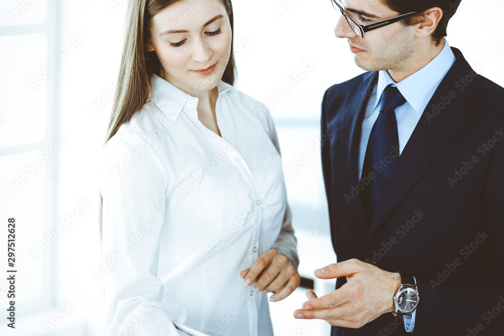 Businessmen and woman using tablet computer in modern office. Colleagues or company managers at workplace. Partners discussing contract. Business concept Businessmen and woman using tablet computer in modern office. Colleagues or company managers at workplace. Partners discussing contract. Business concept