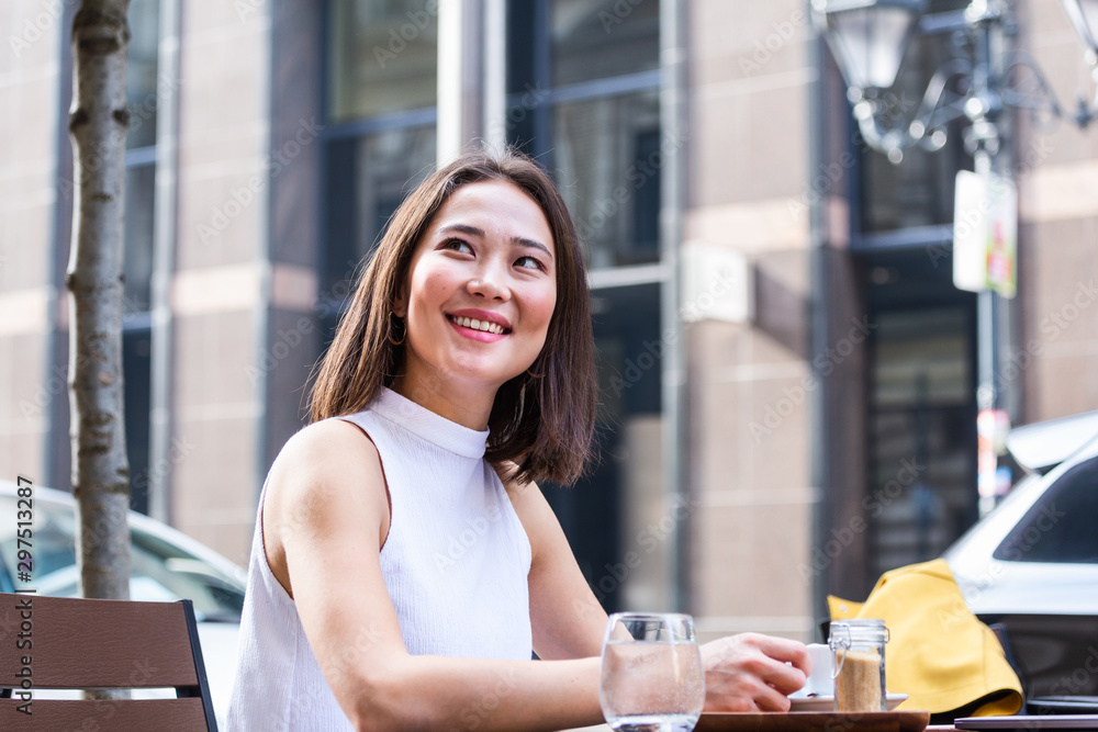 Beautiful young Asian woman with cup of coffee. Woman enjoys fresh coffee in the morning with sunrise at coffe shop Beautiful woman drinking coffee in the morning sitting by the window Beautiful young Asian woman with cup of coffee. Woman enjoys fresh coffee in the morning with sunrise at coffe shop Beautiful woman drinking coffee in the morning sitting by the window