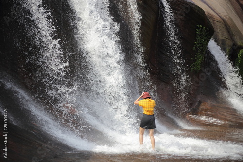 Women playing in the water at Tham Phra Waterfall  in Bueng Kan  Thailand.