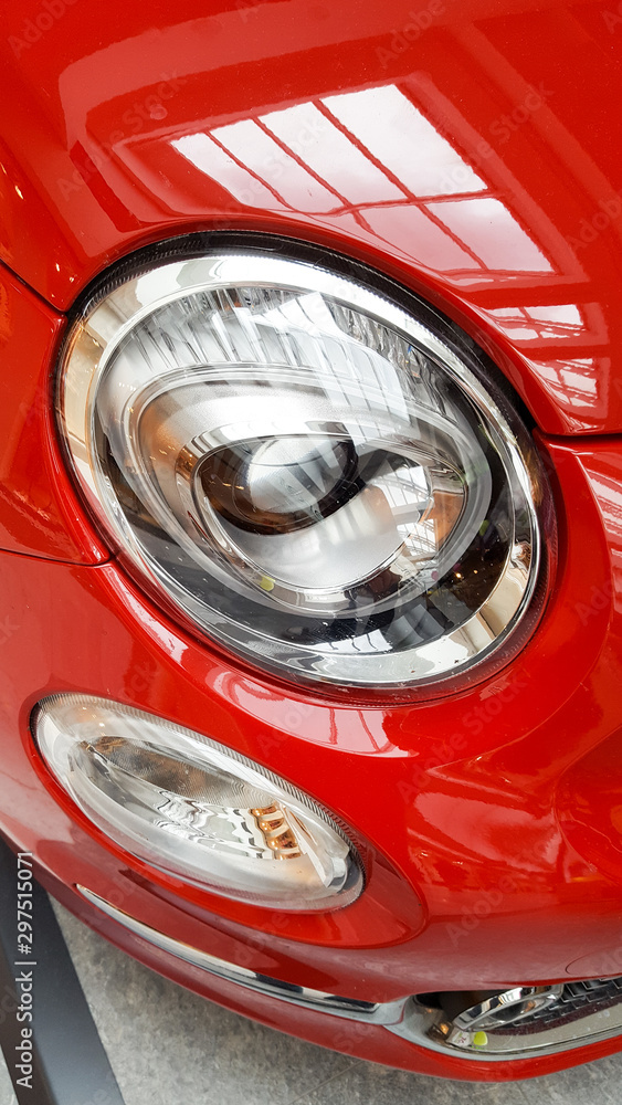 Closeup of red vintage car front parked in the street fiat 500