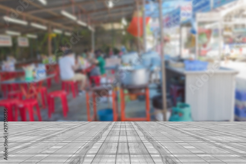 Top desk with blur restaurant background,wooden table,street food stall