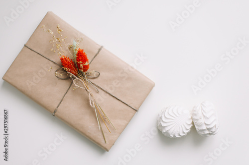 Pretty gift box wrapped with brown craft paper and decorated with jute. Birthday  wedding and girly concept.  
