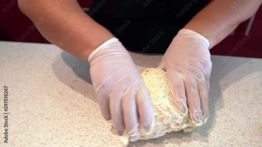 Kneading the dough as it is being prepared for a pie. A woman's hands
