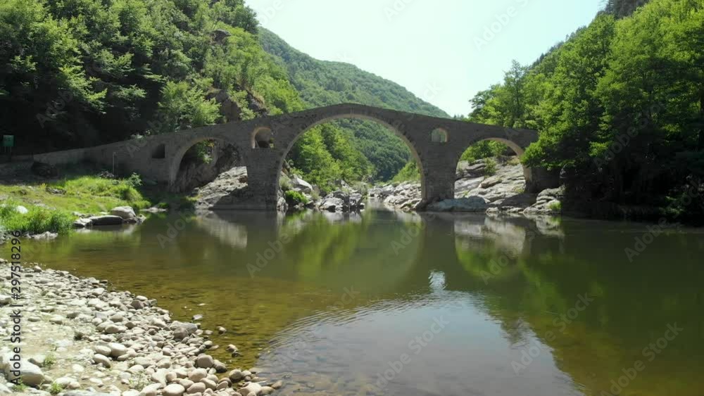 Dolly in towards Devil's Bridge in Bulgaria. Flying low over Arda River. Dolly in towards Devil's Bridge in Bulgaria. Flying low over Arda River.