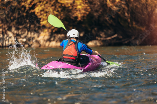Fototapeta Naklejka Na Ścianę i Meble -  Man rafts on a kayak on the river in a sunny day.