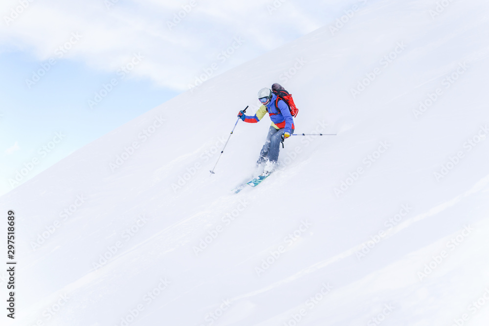 Side photo of sportsman with backpack skiing