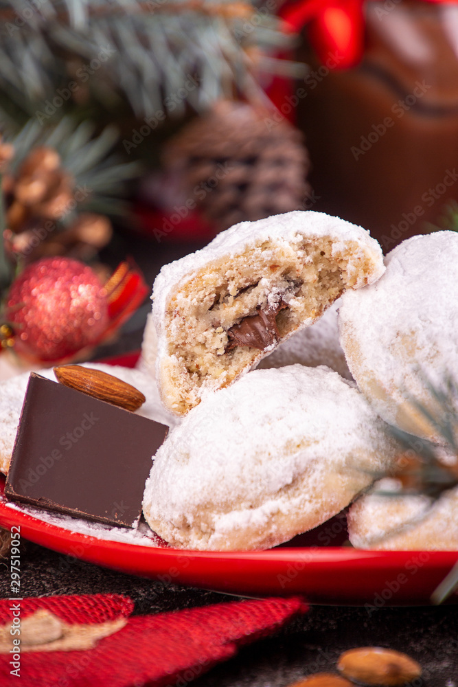 Traditional Christmas cookies biscuits snowballs covered icing sugar povder with almond nut, nutella chocolate an raspberry jam. Christmas New Year ornament decorations. Traditional Christmas cookies biscuits snowballs covered icing sugar povder with almond nut, nutella chocolate an raspberry jam. Christmas New Year ornament decorations.