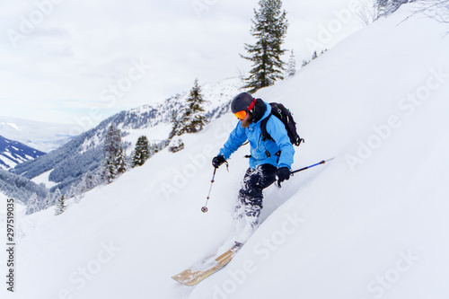 Image of athlete man with beard skiing in winter resort .
