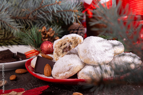 Traditional Christmas cookies biscuits snowballs covered icing sugar povder with almond nut, nutella chocolate an raspberry jam. Christmas New Year ornament decorations. photo