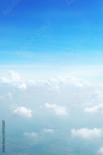 blue sky background with clouds, beautiful cloudscape, view over white fluffy clouds, freedom concept © PARINYA