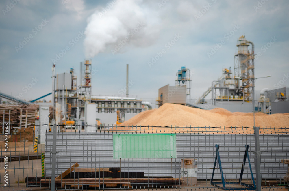 Obraz premium Factory chimneys (chimneys) pollute the air in a green field. Ecological concept. Pollution. Environmental issue.Ecological problem.