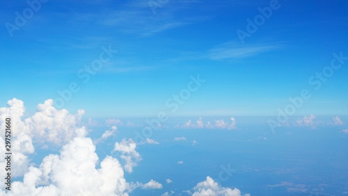 blue sky background with clouds, beautiful cloudscape, view over white fluffy clouds, freedom concept © PARINYA