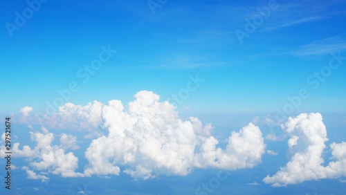 blue sky background with clouds, beautiful cloudscape, view over white fluffy clouds, freedom concept
