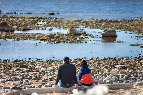 Wallpaper Mural Young coupe having a rest in a Gulf of Finland stone shore in Saint-Petersburg Torontodigital.ca