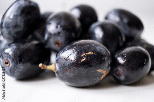 Big black spanish grapes over a white background
