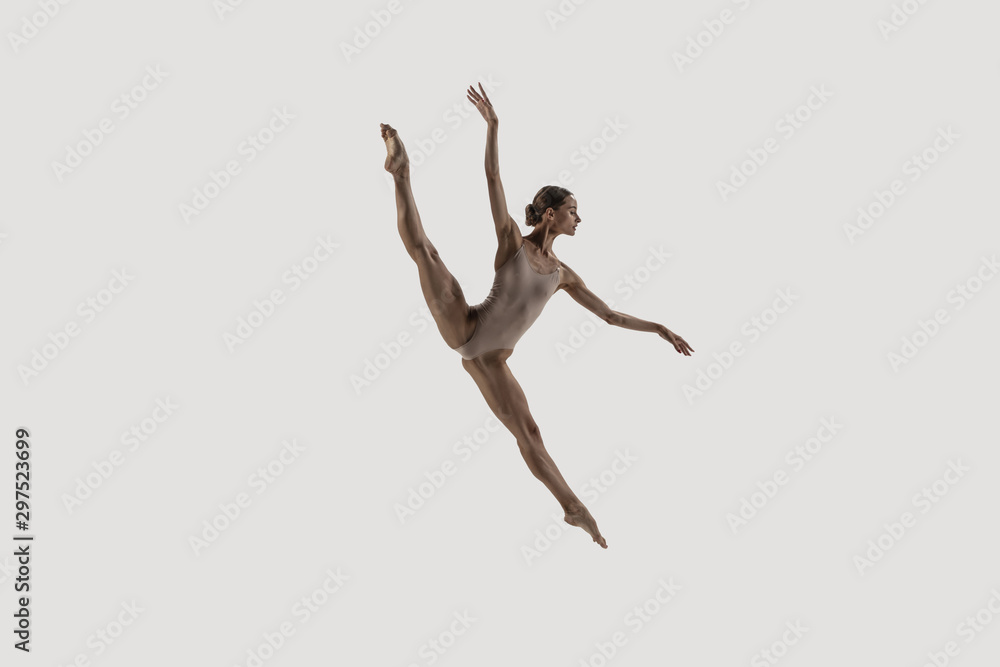 Modern ballet dancer. Contemporary art ballet. Young flexible athletic woman.. Studio shot isolated on white background. Negative space.