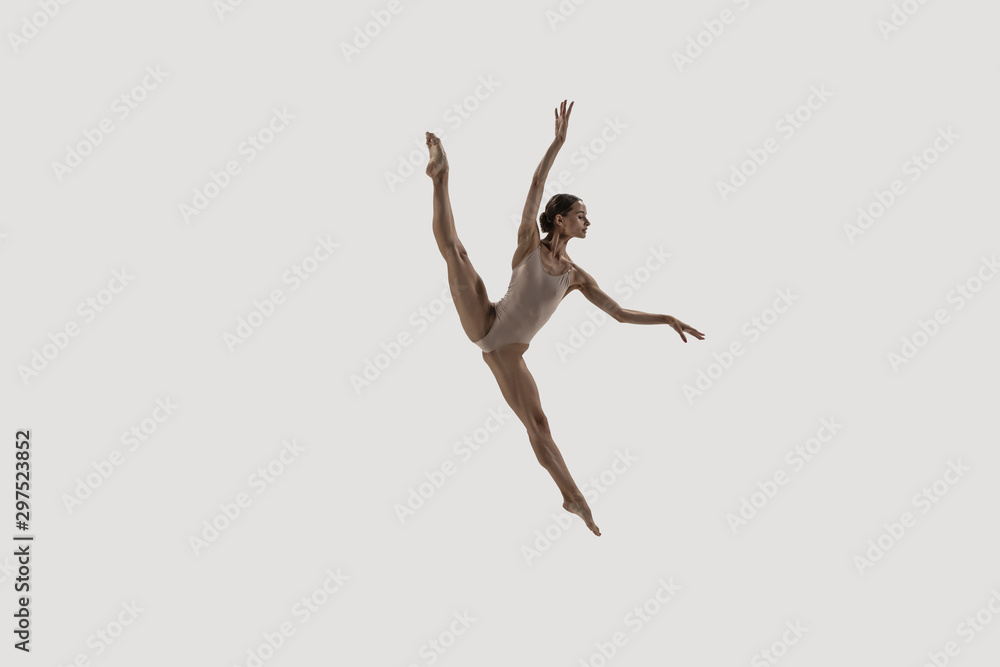 Fototapeta Modern ballet dancer. Contemporary art ballet. Young flexible athletic woman.. Studio shot isolated on white background. Negative space.