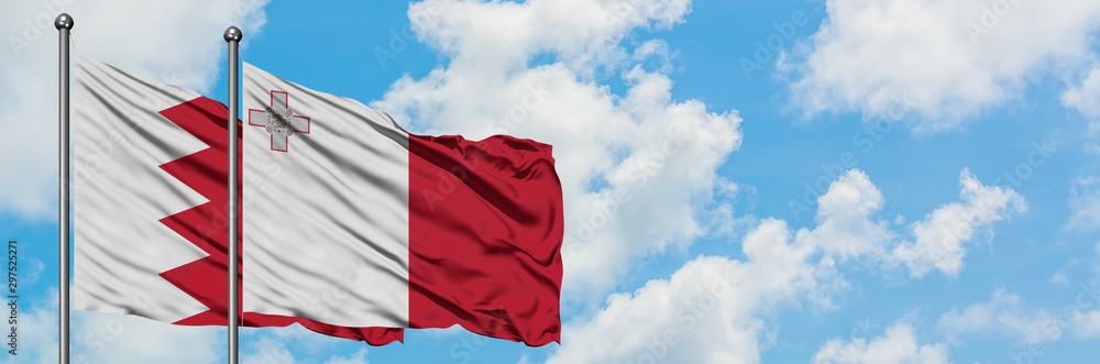 Bahrain and Malta flag waving in the wind against white cloudy blue sky together. Diplomacy concept, international relations. Bahrain and Malta flag waving in the wind against white cloudy blue sky together. Diplomacy concept, international relations.