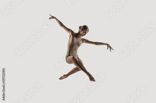 Modern ballet dancer. Contemporary art ballet. Young flexible athletic woman.. Studio shot isolated on white background. Negative space.