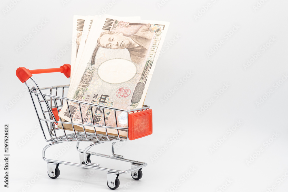 Close up japanese currency yen money banknote in small shopping trolley . Background concept for japan  economy and online market.