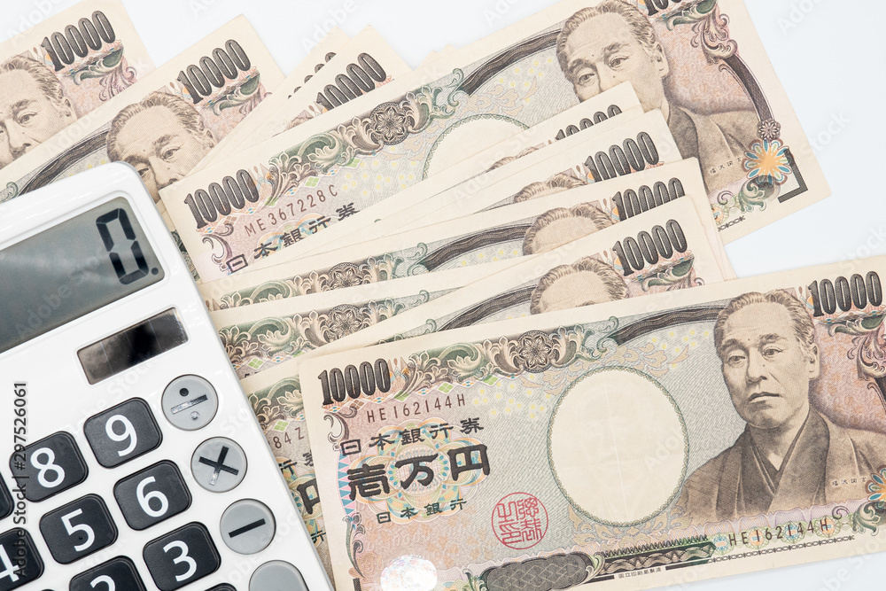 Fototapeta premium Close up calculator on japanese currency yen money banknote. Background concept for japan economy.
