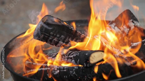 Wallpaper Mural Firewood burning in a small round garden barbeque with really hot black and white coals in it. Daytime. Smoke and flames comming out of it. Torontodigital.ca