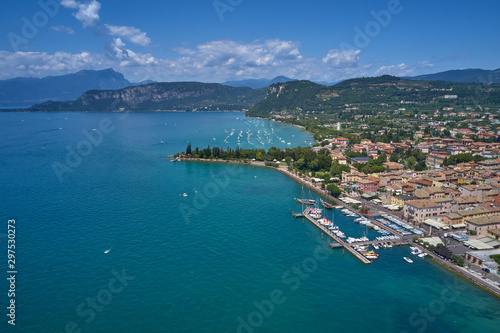 Aerial photography. Beautiful coastline. In the city of Bardolino, Lake Garda is the north of Italy. View by Drone. Docked yachts parking in Port.
