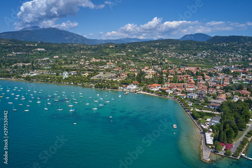 Fototapeta Naklejka Na Ścianę i Meble -  Aerial photography. Beautiful coastline. In the city of Bardolino, Lake Garda is the north of Italy. View by Drone.