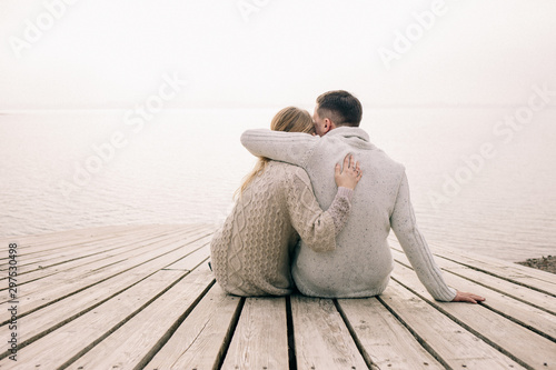 couple hugging on a pier photo