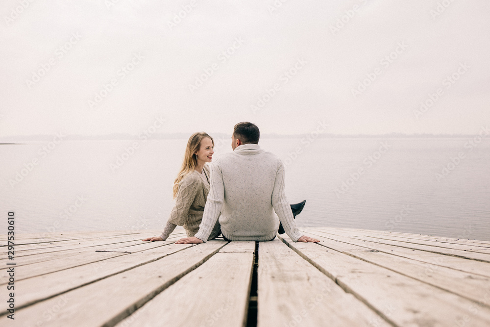 couple hugging on a pier
