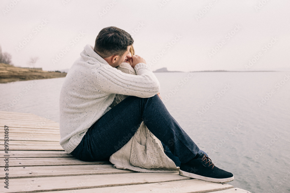 couple hugging on a pier