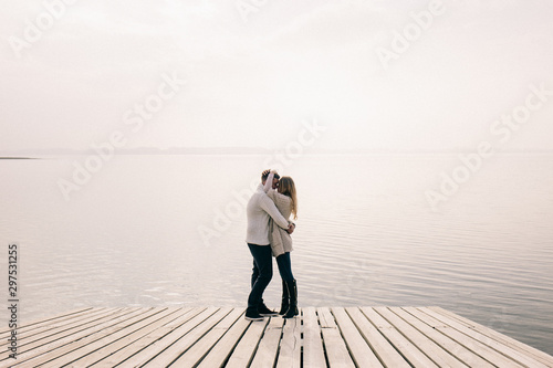 couple hugging on a pier