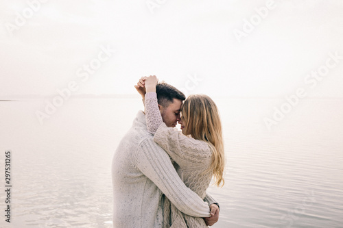 couple hugging on a pier