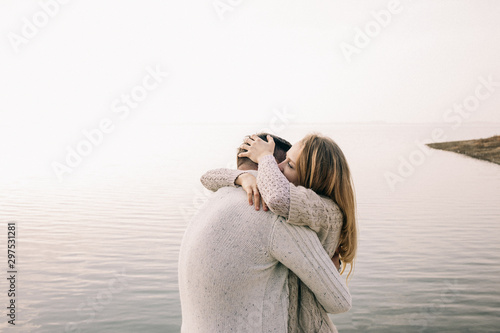 couple hugging on a pier