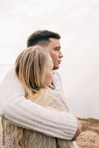 couple hugging on a pier