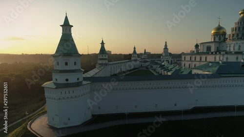 Aerial around Resurrection Cathedral Istra orange sunset New Jerusalem Monastery complex Orthodox best Russia temple church golden domes cross Patriarch Nikon. Reconstruction Culture Belief Faith