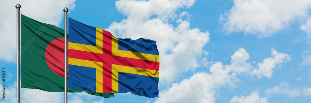 Bangladesh and Aland Islands flag waving in the wind against white cloudy blue sky together. Diplomacy concept, international relations. Bangladesh and Aland Islands flag waving in the wind against white cloudy blue sky together. Diplomacy concept, international relations.