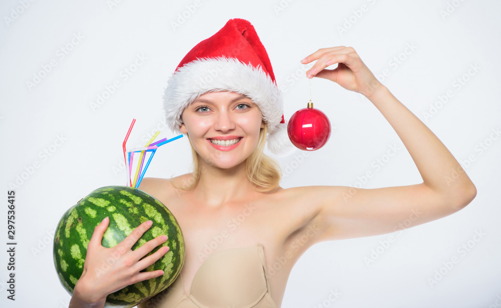Winter fruit guide. Woman enjoy watermelon cocktail. How to detox after christmas. Watermelon dietary beverage. Girl wear santa hat hold ornament ball drink watermelon cocktail. Vitamin nutrition Winter fruit guide. Woman enjoy watermelon cocktail. How to detox after christmas. Watermelon dietary beverage. Girl wear santa hat hold ornament ball drink watermelon cocktail. Vitamin nutrition