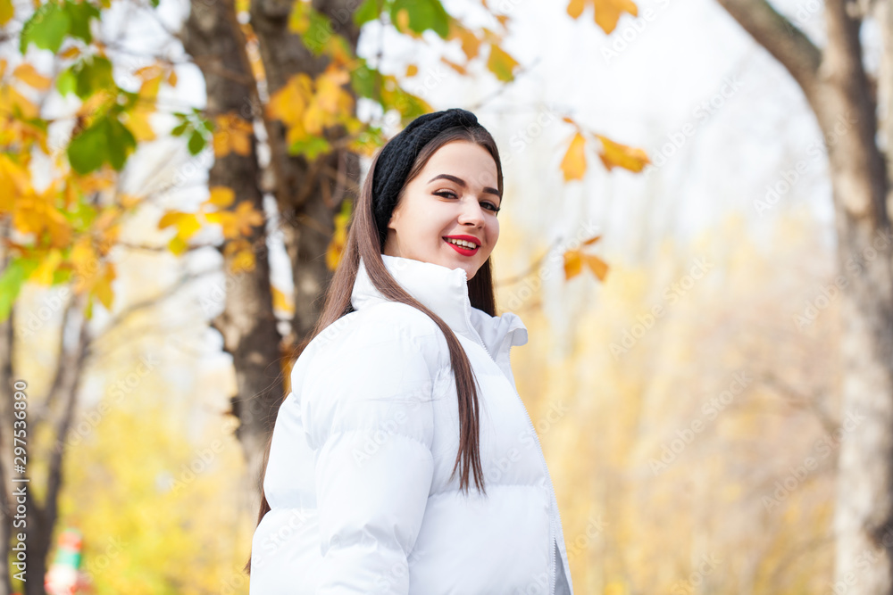Portrait of a young beautiful woman in a white down jacket Portrait of a young beautiful woman in a white down jacket