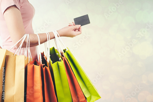 woman with colorful shopping bags and holding credit card ,isolated on bokeh background