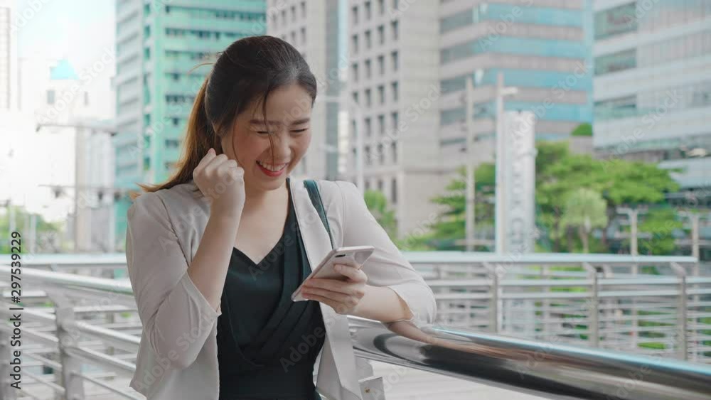 Shot of the Beautiful Business woman looking on phone in celebration of a Successful Job Promotion. 4K Slow Motion corporate shot Shot of the Beautiful Business woman looking on phone in celebration of a Successful Job Promotion. 4K Slow Motion corporate shot