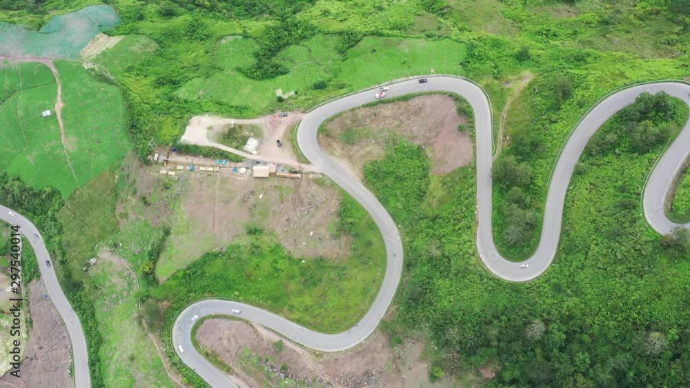 The aerial view of winding road from high mountain pass in Phutabberk, Thailand, Curved road view by drone. The aerial view of winding road from high mountain pass in Phutabberk, Thailand, Curved road view by drone.