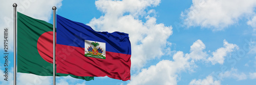 Obraz na płótnie Bangladesh and Haiti flag waving in the wind against white cloudy blue sky together