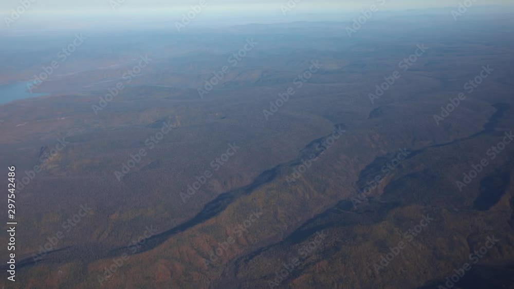 Visas from the porthole of an airplane. View of the Primorsky mountains, villages and fields from the window of a domestic aircraft. Visas from the porthole of an airplane. View of the Primorsky mountains, villages and fields from the window of a domestic aircraft.