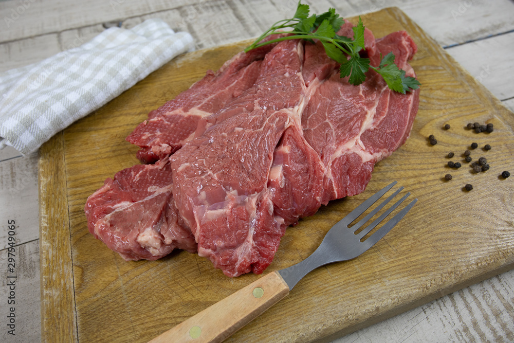 big raw steak on a cutting board