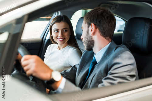 selective,focus,of bearded man driving car and looking at girl