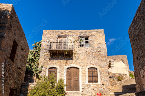 Old buildings and ruins of Spinalonga on a sunny day. photo