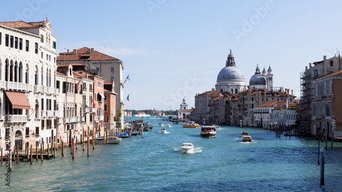 Beautiful view of the Basilica di Santa Maria della Salute from the Grand Canal bridge in Venice, Italy. © ClauRiveraE