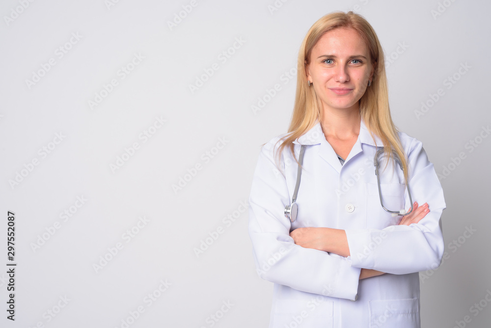 Portrait of young beautiful blonde woman doctor with arms crossed Portrait of young beautiful blonde woman doctor with arms crossed