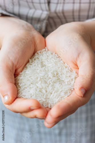 Woman hands holding a white rice.